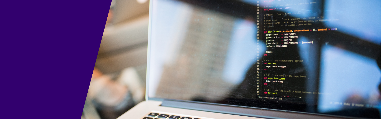 Computer code displayed on a laptop screen with the reflection of person on the screen