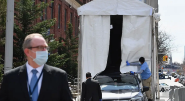 Car backing into refrigerated truck on New York City street