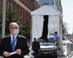 Car backing into refrigerated truck on New York City street