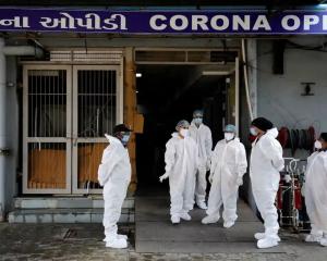 Healthcare workers stand at the entrance of a Covid-19 hospital in Ahmedabad in January 2022. Photograph: Amit Dave/Reuters