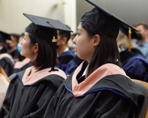 Two student graduates in MS Capstone Program attending 2022 graduation event