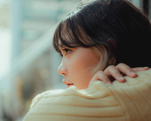 Photo of woman looking out window