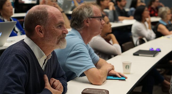 Patrick Heagerty listening to a Biostatistics lecture with colleagues