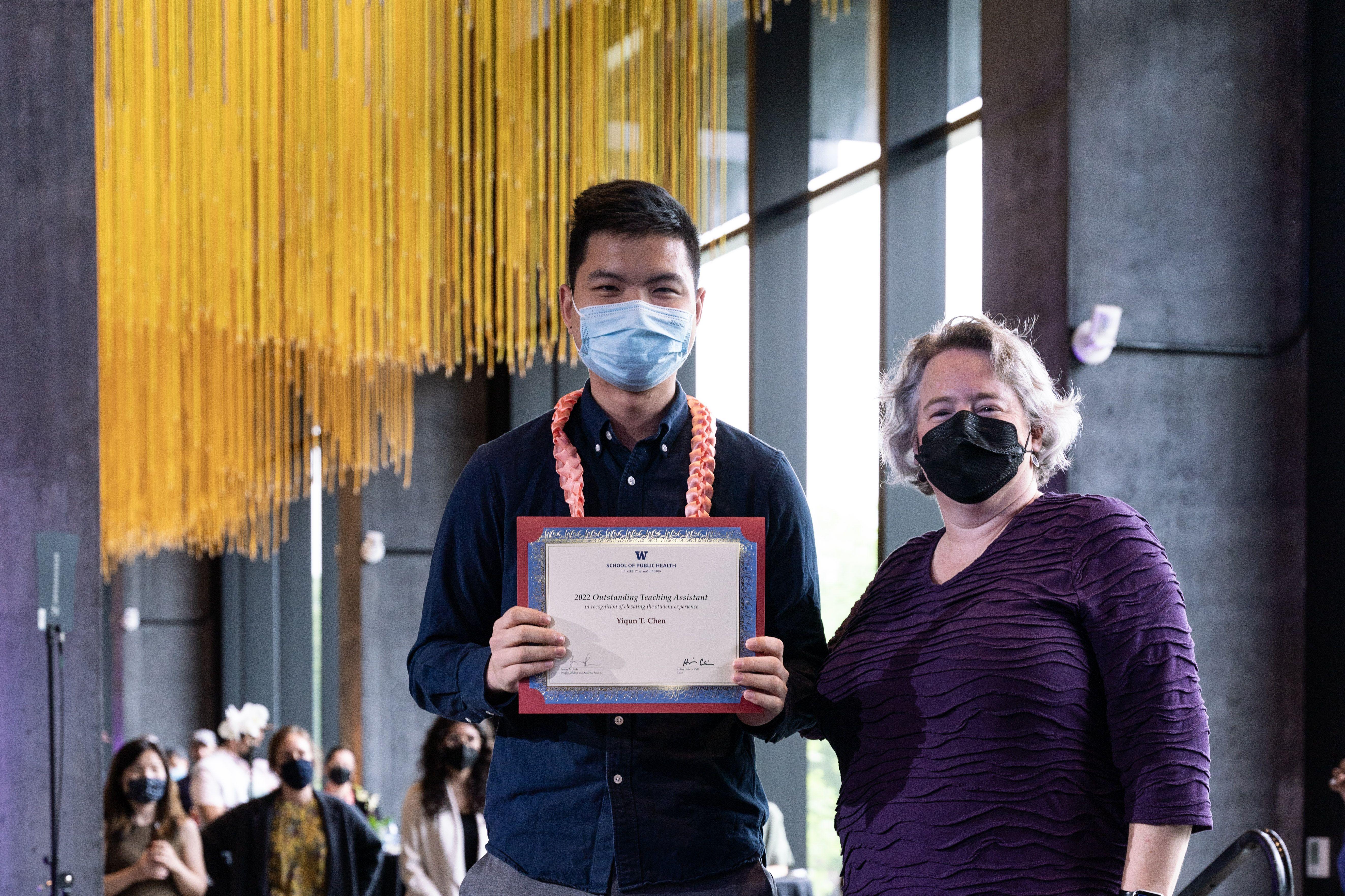 Yiqun Chen receives award certificate from SPH Dean Hillary Godwin