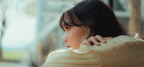 Photo of woman looking out window